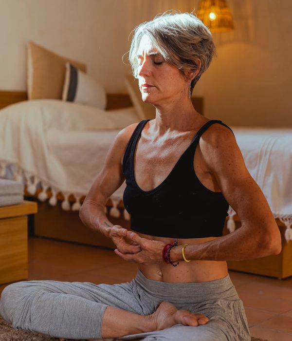 Serene woman with closed eyes, focusing on inner peace and well-being.